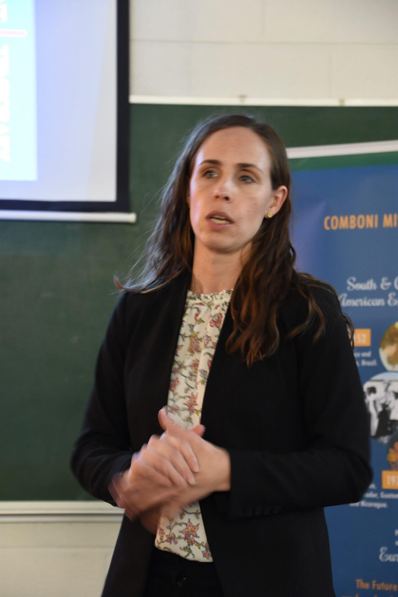 Elizabeth Clapp, Director of Immigration Legal Services at Catholic Charities of Southwest Ohio, speaks to a crowd at the Comboni Mission Center.