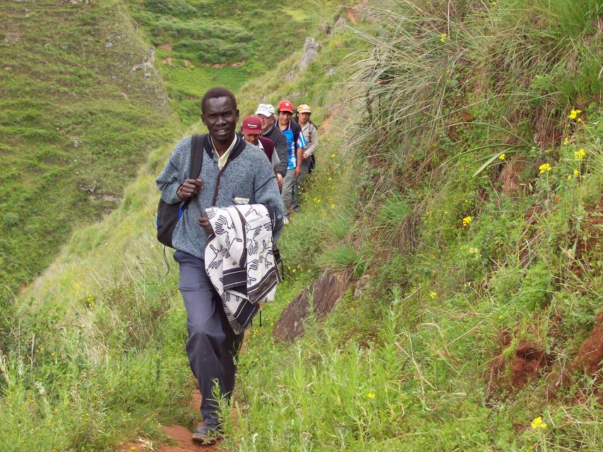 Fr. Louis hikes along a mountain trail with lay people
