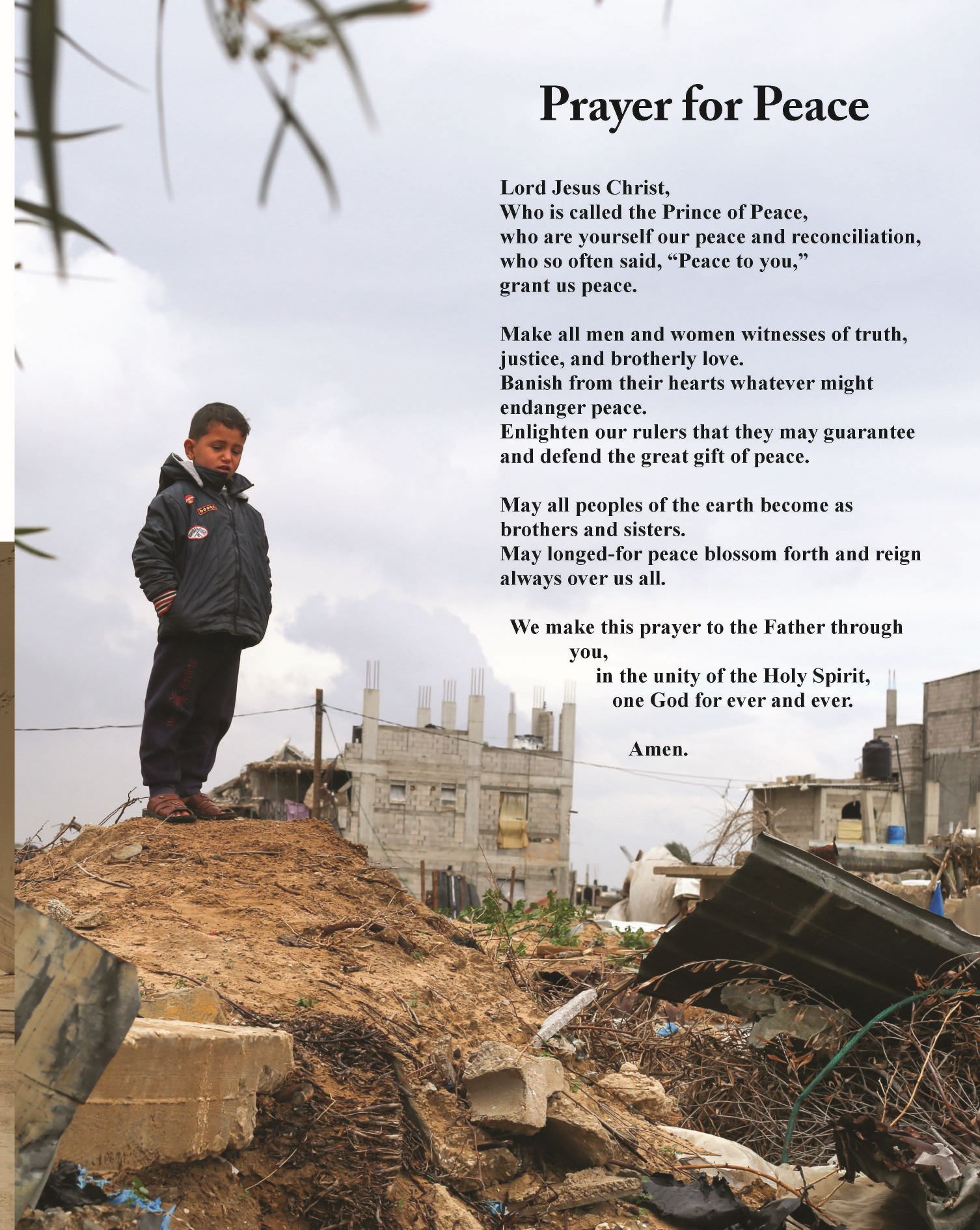 A young boy stands on rubble with destroyed buildings in the background