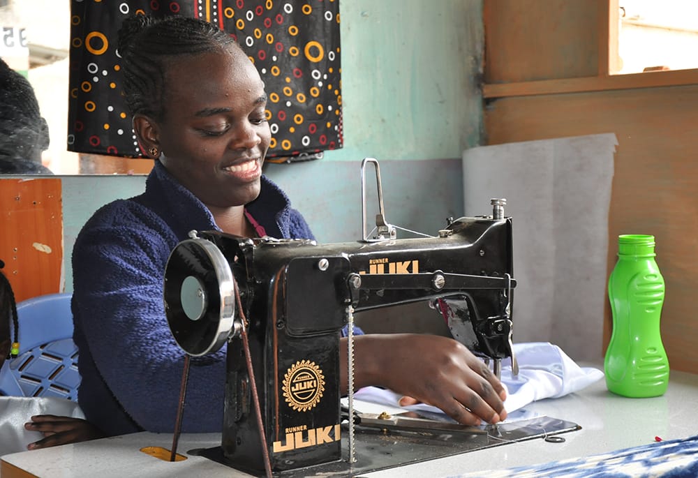 Lynn Chepng'eny is pictured at her dressmaking business in Kariobangi North in Nairobi.