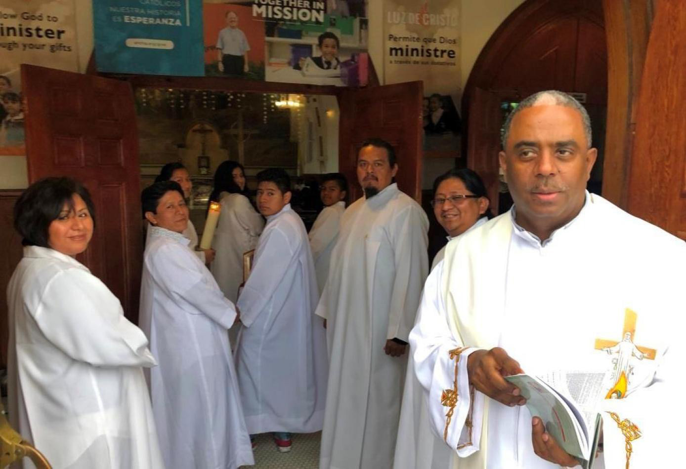 Fr Tesfaye wears vestments and prepares to enter the nave for Mass